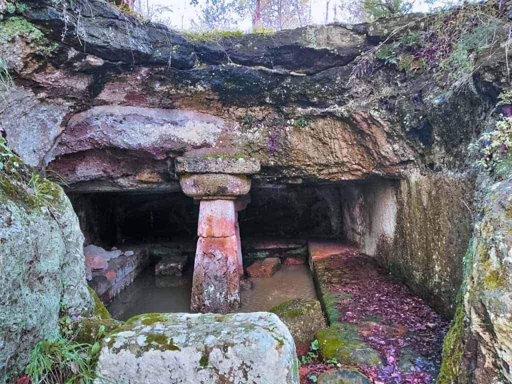 Italian Landmarks you need to visit include the Etruscan Necropolis where a single stone arch sits in the middle of a small cave near Rome.